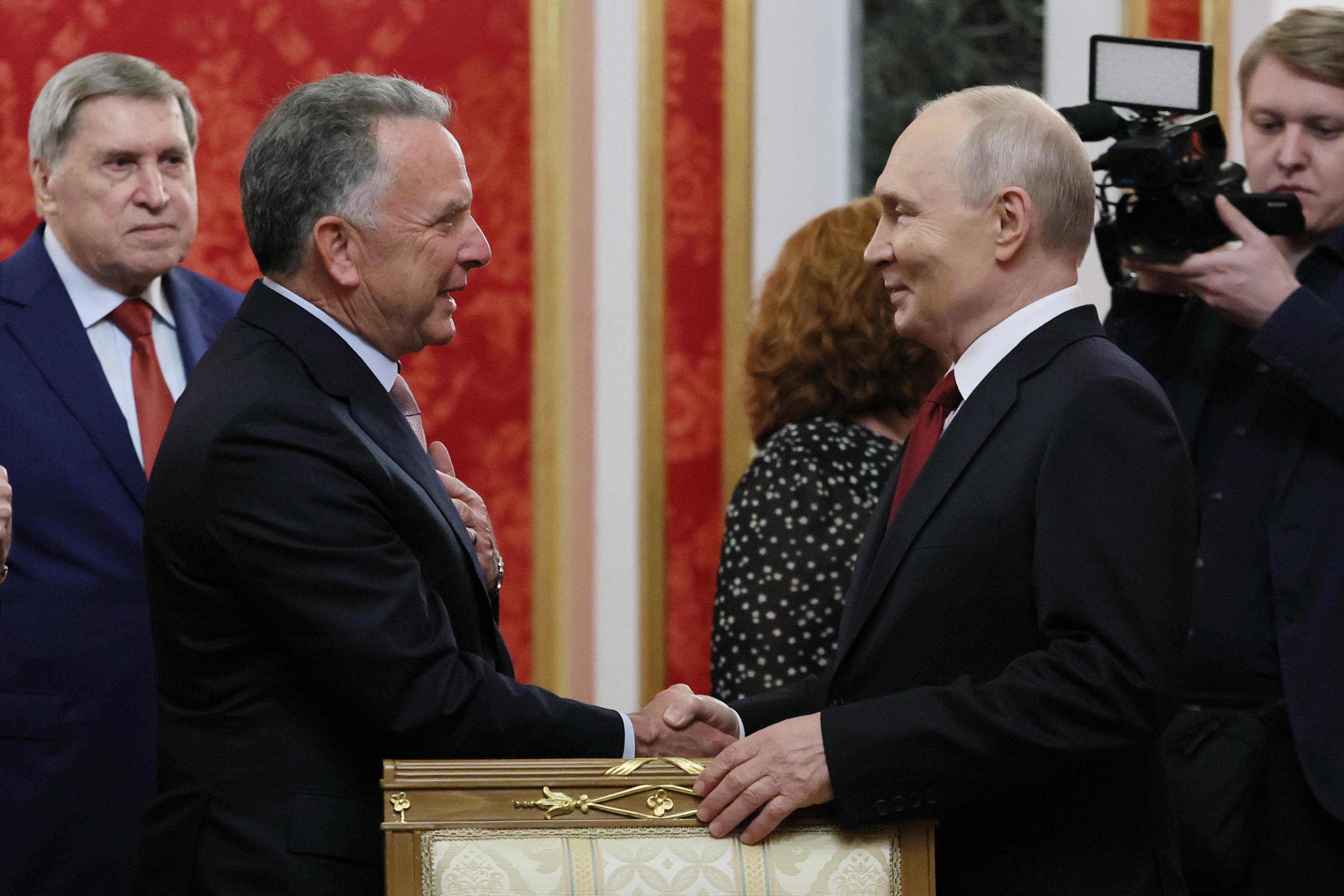 President Vladimir Putin, right, greets U.S. President Donald Trump